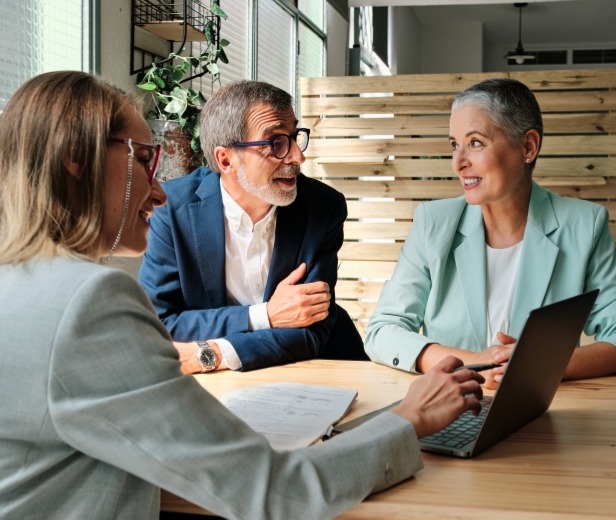 A man and woman speaking with an analyst, suggesting estate planning advice